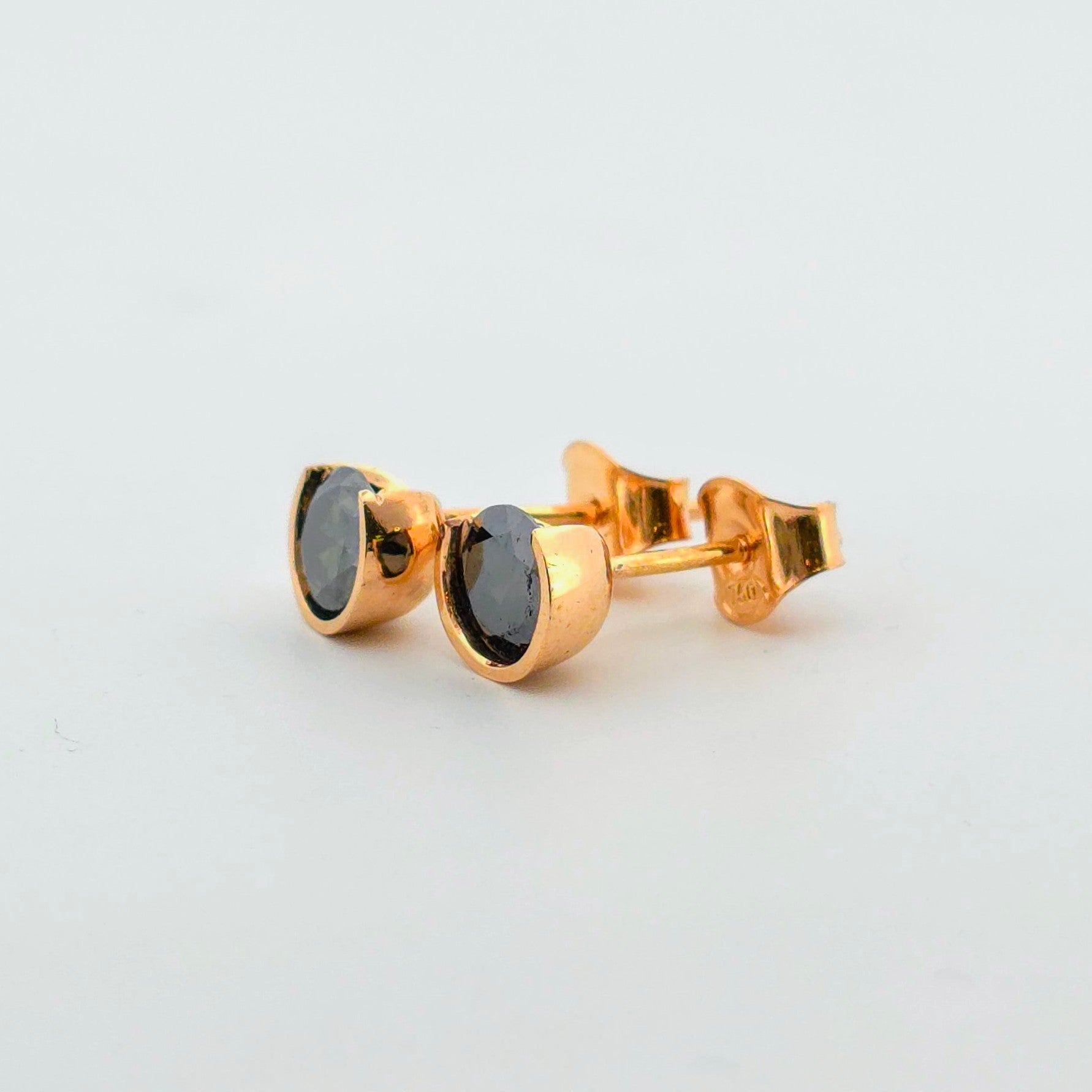 Exklusiva örhängen i 18 karat guld med mörk ädelsten – en lyxig och stilfull accessoar för både vardag och fest eller som en present till henne.